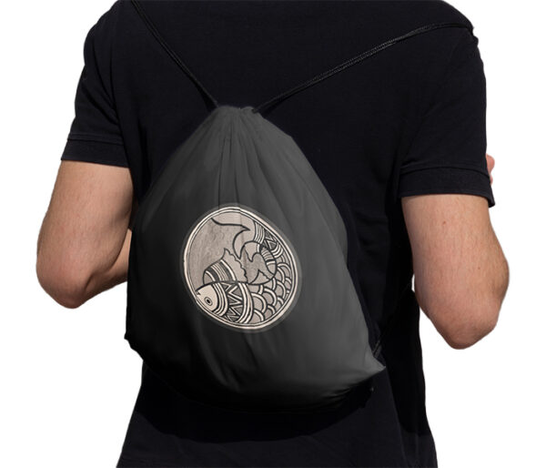 Man carrying Madhubani Art Fish Drawstring Bag Black